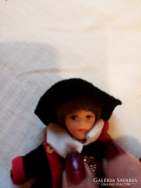 Porcelain doll in traditional clothes, small size