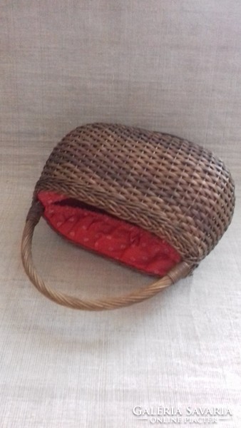 Old small-sized children's hand-woven basket with small canvas rubber interior.