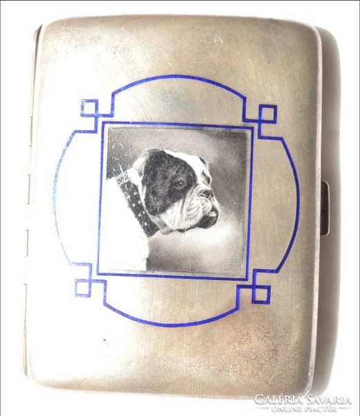 A picture depicting a fire enamel dog on a silver wallet