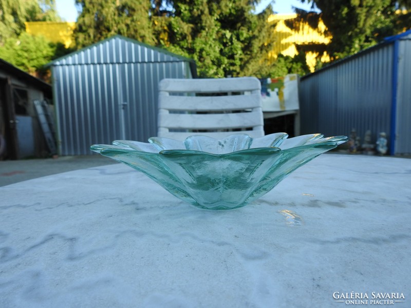A pale green glass centerpiece in the shape of a petal