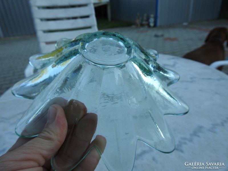 A pale green glass centerpiece in the shape of a petal