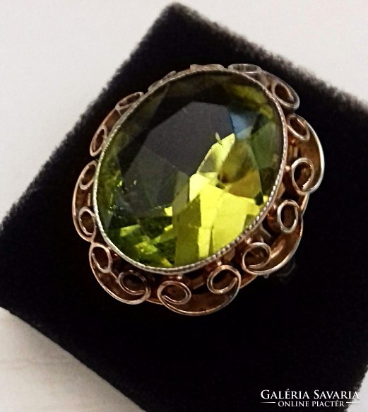 Old gold-plated filigree ring decorated with a green polished stone