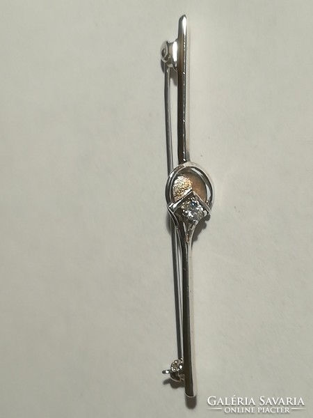 Silver brooch with badge.