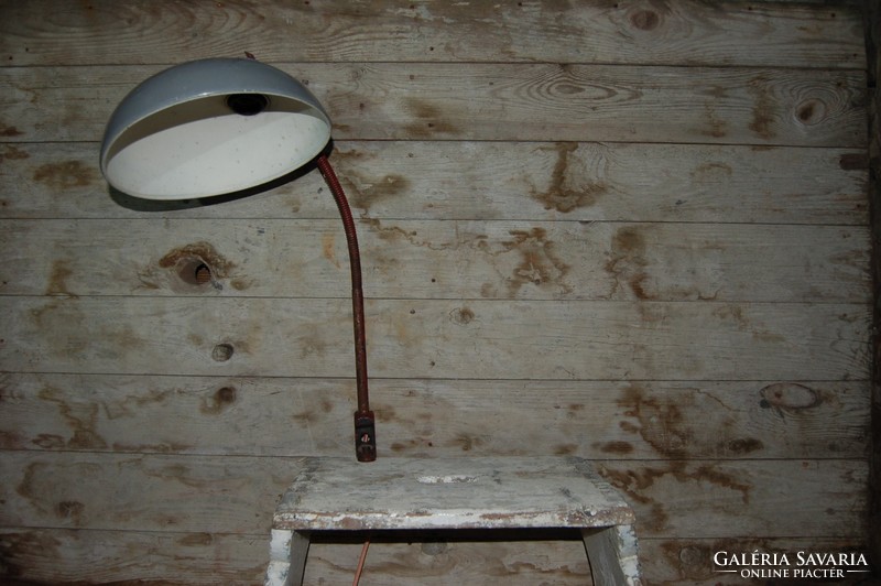 Workshop lamp with a large, enamelled metal shade.