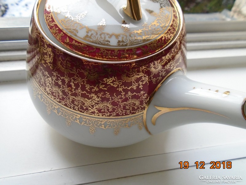 Imperial elbogen tea pourer with gold brocade patterns, mythological scene impressed sword arm insignia