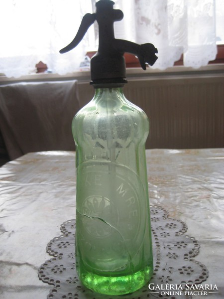 Soda bottle, the text is the same on the head and the bottle / blond waiter /