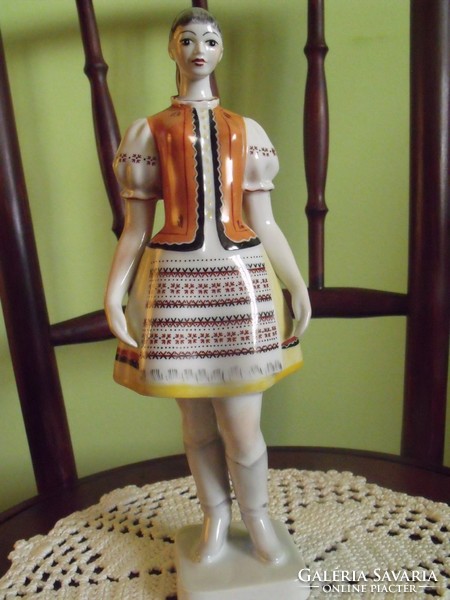 Girl in folk costume in raven house