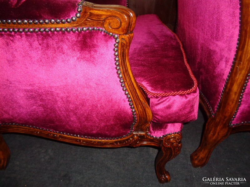 Antique baroque armchairs paired with burgundy velvet upholstery