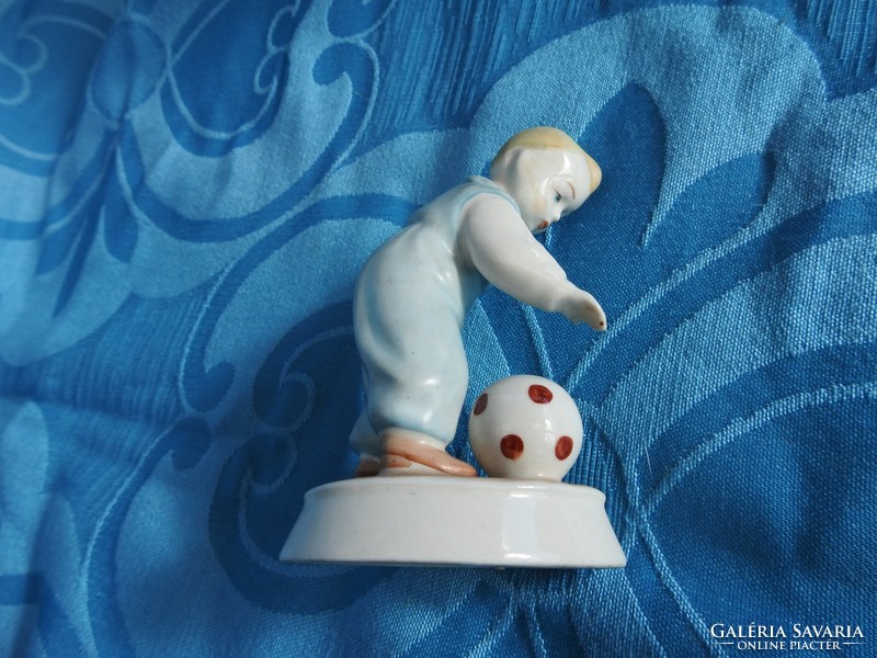 A small child playing with a ball - Zsolnay porcelain figure
