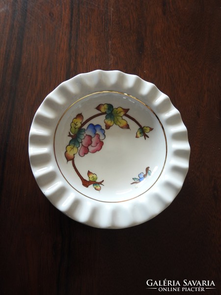 A centerpiece serving bowl with a floral design with a ribbed rim