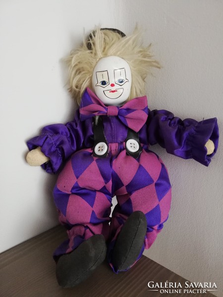 Clown in purple and white checkered dress with antique porcelain head