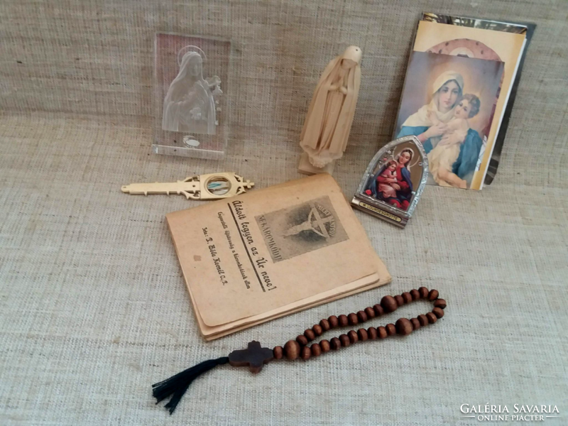 Old prayer books in glass frames with a small picture of Mary and her child