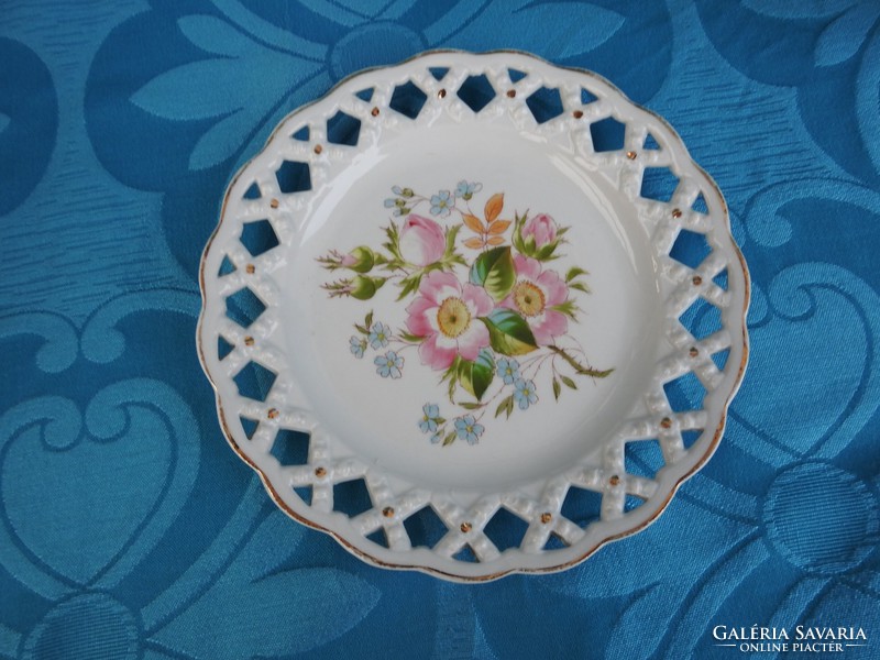 Antique flower-patterned Austrian decorative plate with an openwork basket weave pattern on the rim.