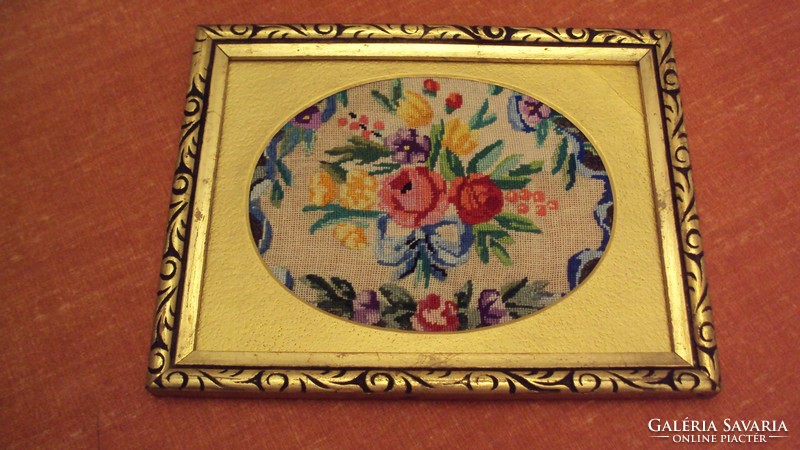 Antique, flower-patterned needle tapestry in gold passe-partout, carved in a gold-glossed wooden frame.