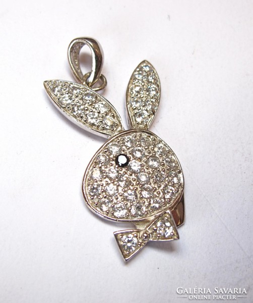 Large silver playboy pendant with stones.