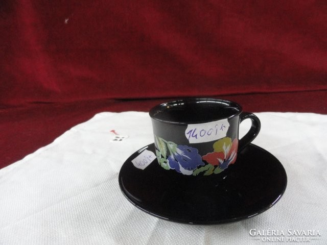 French porcelain coffee cup + placemat. Floral pattern on a black background. He has!