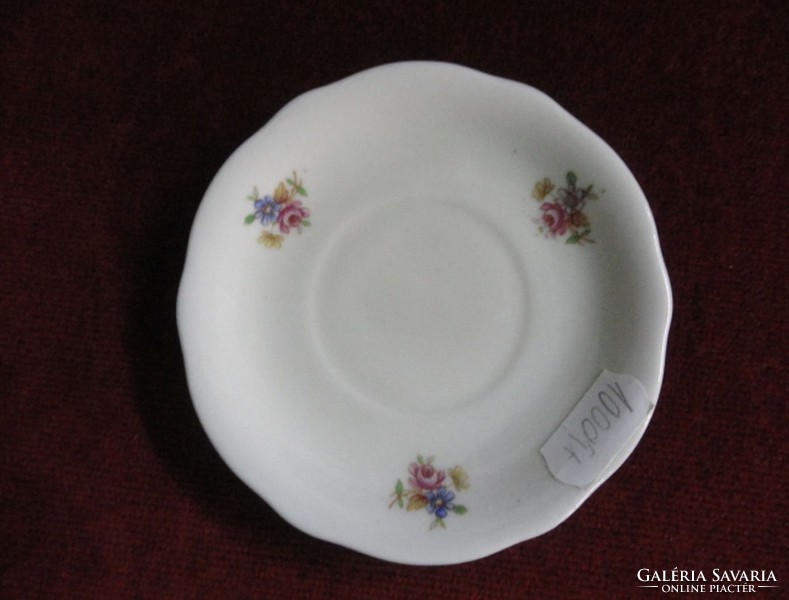 Zsolnay porcelain coffee cup placemat. Cream-colored with a small floral pattern. Antique. He has!