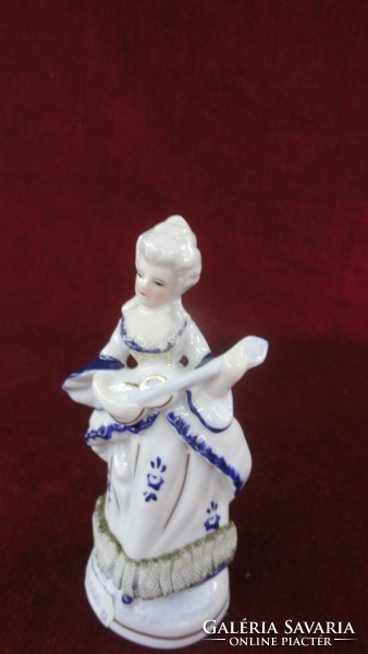 Hand-painted porcelain, cobalt blue colored musical girl in a dress with a lace bottom. He has!