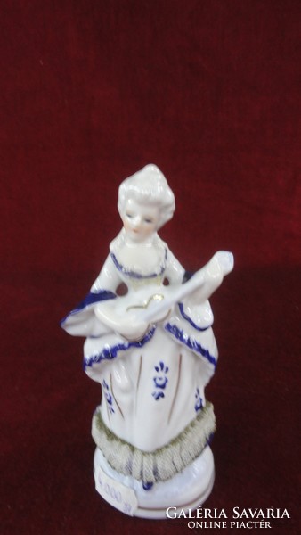 Hand-painted porcelain, cobalt blue colored musical girl in a dress with a lace bottom. He has!