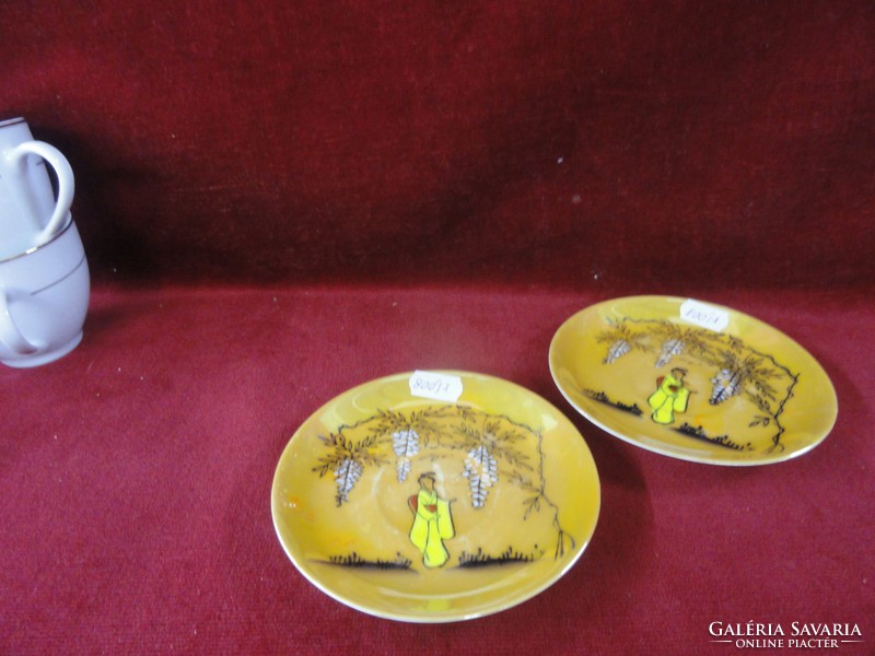 Japanese eggshell porcelain tea cup + saucer. There is a picture of a Geisha in the middle. He has!