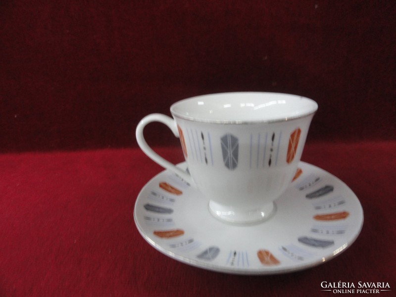 Oriental porcelain tea cup + saucer, with gray/brown pattern. He has!