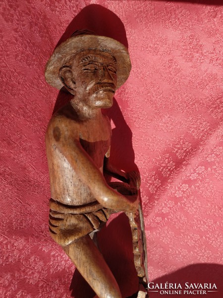 Old wood carving, fisherman casting his net