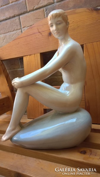 Woman sitting on rare zsolnay stone