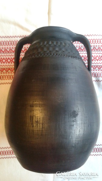 Two-eared black ceramic jug