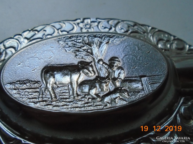 With a bucolic hilly landscape, cows resting under an oak tree and a shepherd, metal table decoration