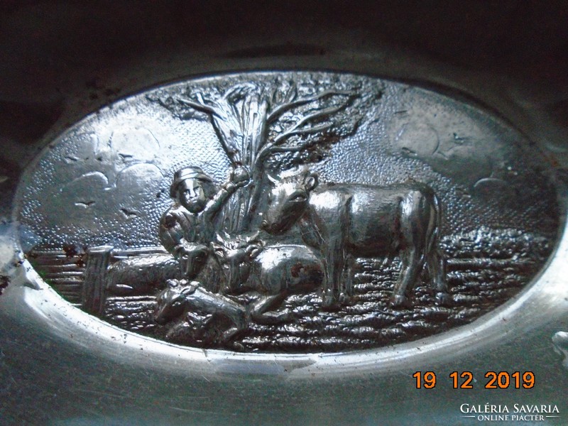 With a bucolic hilly landscape, cows resting under an oak tree and a shepherd, metal table decoration