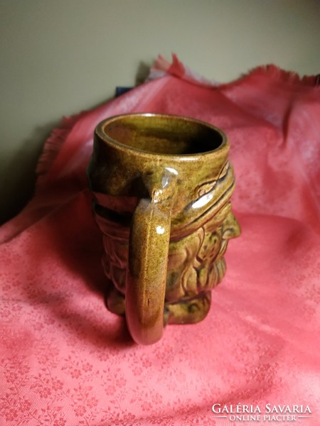 Ceramic jug with a human head