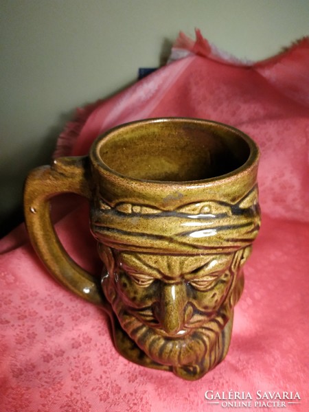 Ceramic jug with a human head
