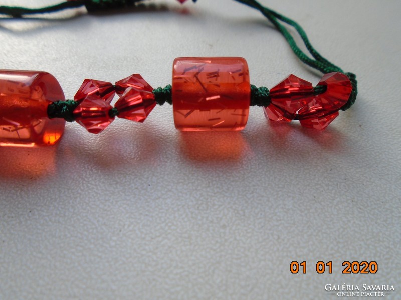 Red currant-colored glass beads, crocheted with a green cord, bracelet