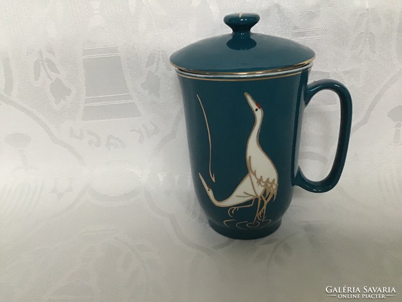 Egret in gilded cup with lid