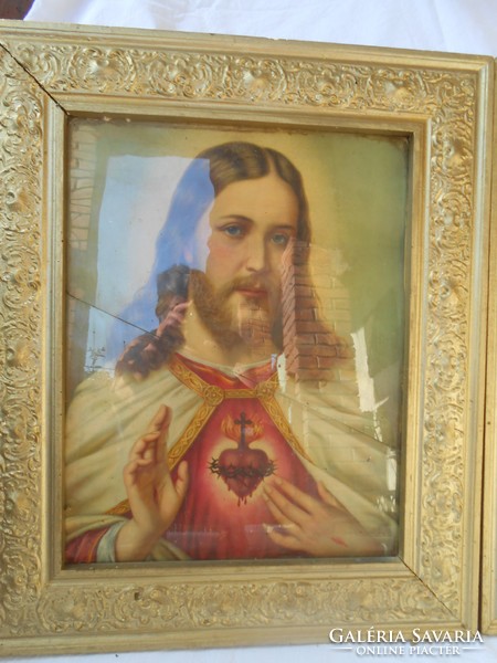 A pair of holy pictures in a golden frame