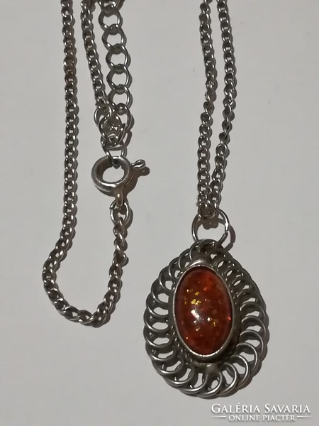 An old necklace, perhaps with an amber pendant.