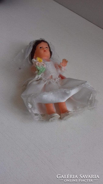 Old retro rubber doll in good condition in a wedding dress