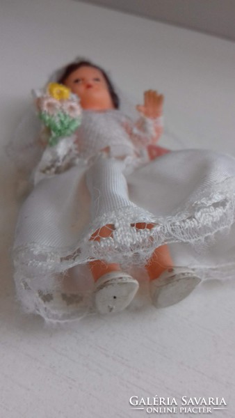 Old retro rubber doll in good condition in a wedding dress