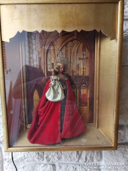 Antique home altar with gothic church interior decorated with wax statue of Mary.