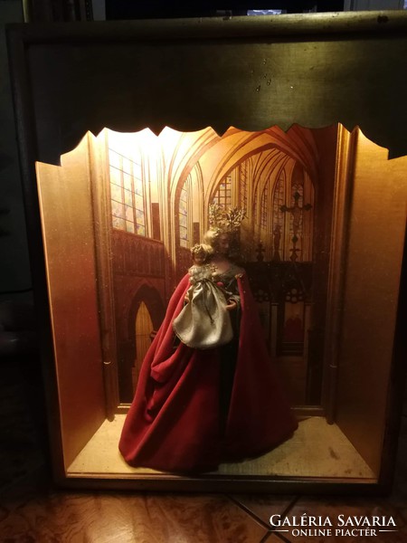 Antique home altar with gothic church interior decorated with wax statue of Mary.