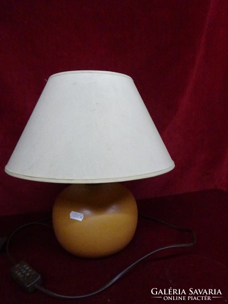 Reading lamp with ceramic base and paper cover. He has!