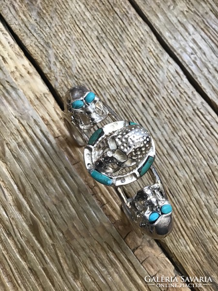 Silver bracelet decorated with special skulls with turquoise stones