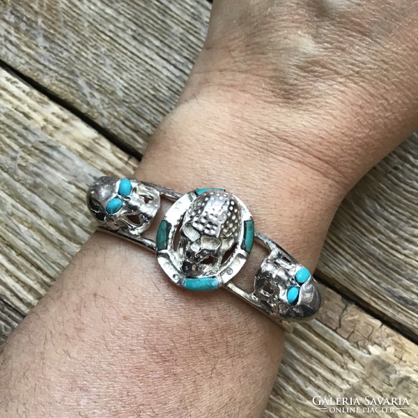 Silver bracelet decorated with special skulls with turquoise stones