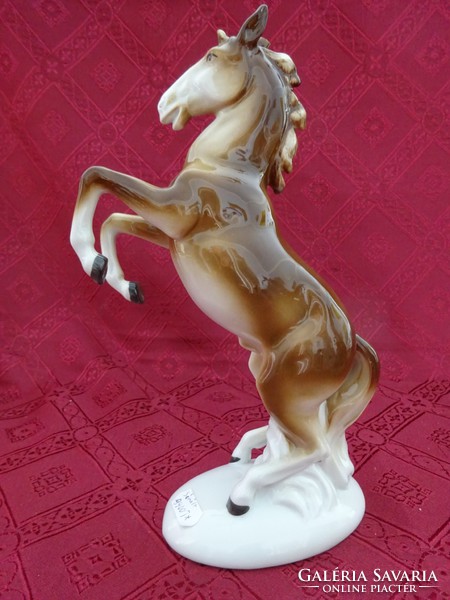 German porcelain figural statue, prancing horse, height 24.5 cm. His right ear is damaged. He has!