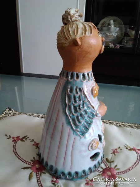 Small pink ceramic sculpture with an openwork flower motif at the bottom of the skirt!
