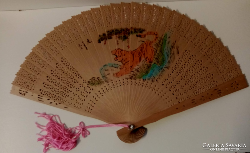 Retro beautiful openwork wooden fan with a picture painted on both sides with a silk tassel at the end