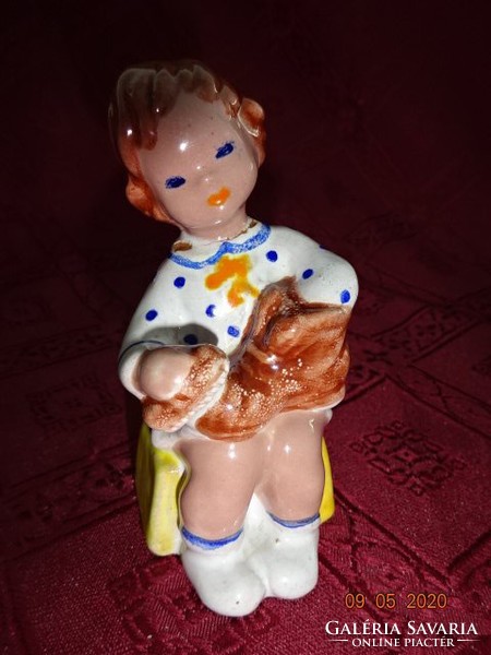 Glazed ceramic figure, girl taking off her shoes, height 10 cm. He has!