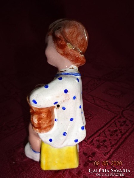 Glazed ceramic figure, girl taking off her shoes, height 10 cm. He has!