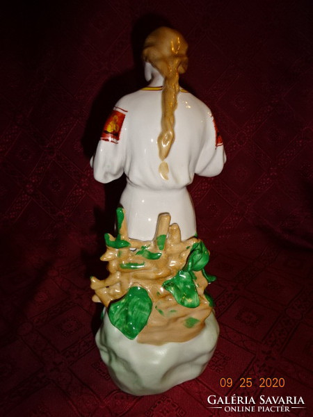Russian porcelain statue, girl counting flower petals. He has!