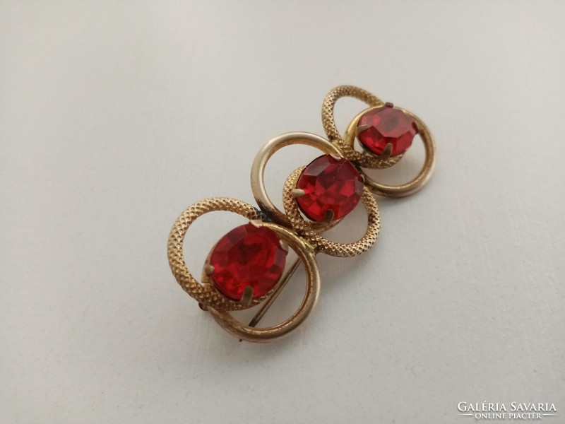 Old filigree brooch set with large red stones